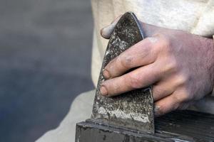 Old retired man hands working slate photo