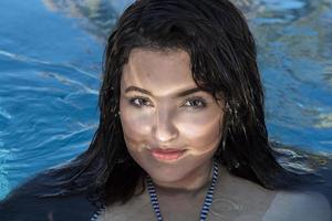 smiling black hair mexican latina girl portrait in Jacuzzi photo