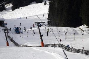 many skiers skiing in dolomites gardena valley snow mountains photo