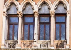 window of medieval palazzo on street contra photo