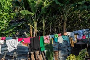 dress driying outside poor hovel, shanty, shack photo