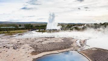 Strokkur geyser eruption and Geysir in Haukadalur photo