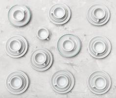 top view of many cups on saucers on concrete board photo