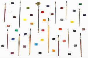 top view of paint brushes and watercolors arranged photo