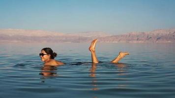 Beautiful woman swimming in the dead sea video