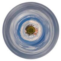 planet with forest and hoses in grey autumn clouds photo