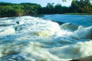 The forest water in the mountain area flows very strongly. photo