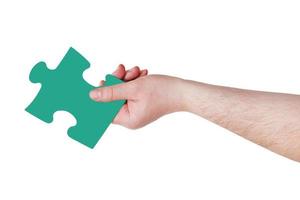 male hand with green puzzle piece photo