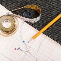 pattern, measuring tape, pencil, pins, tweed coat photo