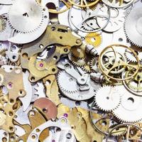 pile of old watch spare parts close up photo