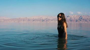 Beautiful woman swimming in the dead sea video