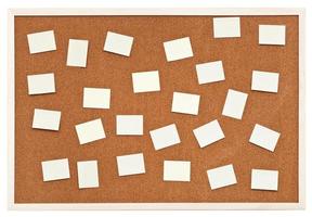 many small sheets of paper on bulletin cork board photo