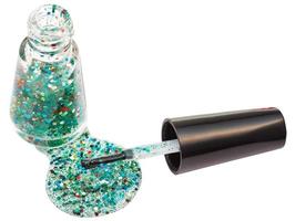 bottle with spilled glitter nail polish isolated photo