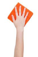 top view of hand with orange cleaning rag isolated photo