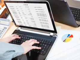 businessman runs with laptop at office desk photo