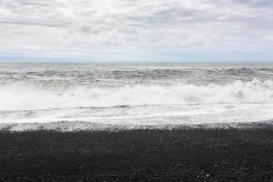 ocean surf on Reynisfjara Beach in Iceland photo