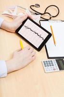 physician checks patient electrocardiogram photo