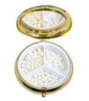 compact pill box with mirror and homeopathy balls photo