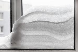 snowdrift between two window glasses photo
