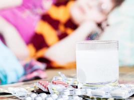 drug dissolves in water and pill on table close up photo