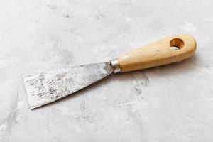 metal spatula with wooden handle on floor photo