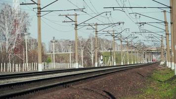 Front view, electrotrain approaches. There is railway, electric line system in picture. video