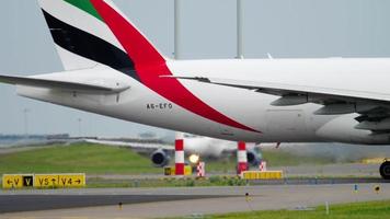 AMSTERDAM, THE NETHERLANDS JULY 24, 2017 - Emirates SkyCargo Boeing 777 A6 EFO and Small Planet Airbus A320 D ABDB taxiing before take off at Polderbaan 36L, Shiphol Airport, Amsterdam, Holland video