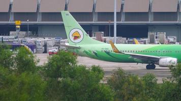 PHUKET, THAILAND NOVEMBER 28, 2019 - Boeing 737, HS DBG of NOK Air taxiing at Phuket International Airport, Thailand HKT. Travel and tourism concept video