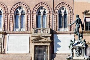 view on Fountain of Neptune and wall of town hall in Bologna photo