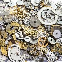 pile of used watch spare parts close up photo