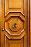 wood door with brass ring door knocker in Rome photo