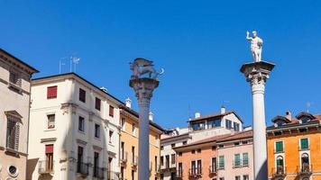 statues on tops of columns at Piazza dei Signori photo