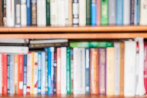 defocused background from books on bookshelf photo