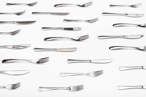 side view of many table knives and forks photo