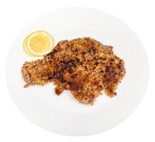 fried veal schnitzel and lemon slices on plate photo