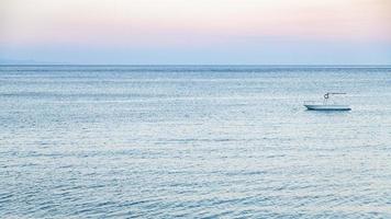 view of boat in Ionian sea in summer twilight photo