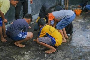 A group of small children having fun winning coins at the Indonesian Independence Day competition in Blitar photo