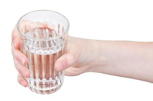 hand holds natural water in glass photo