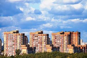 heavy low blue clouds over apartment buildings photo