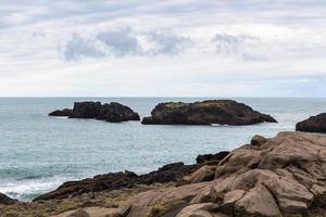 rocky ocean coastline in Iceland photo