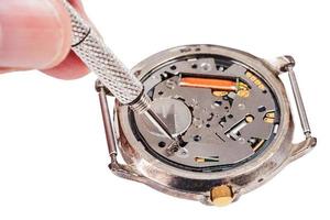 repairer replaces battery in quartz watch isolated photo