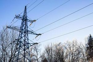 transmission tower of power line in winter photo