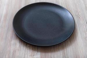 black plate on gray brown table photo