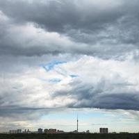 grey rainy clouds over city in summer photo