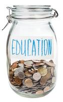 saved coins for education in closed glass jar photo