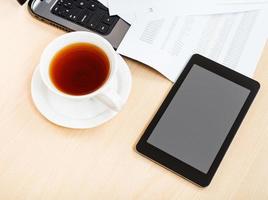 above view cup of tea and tablet pc on desk photo