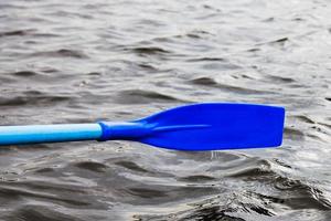 oar blade over the water during rowing boat photo