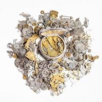 top view of pocket watch on heap of spare parts photo