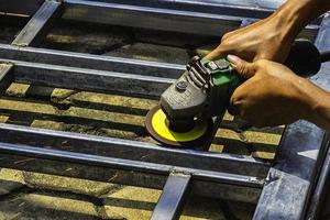 Man's hand grinding steel construction photo