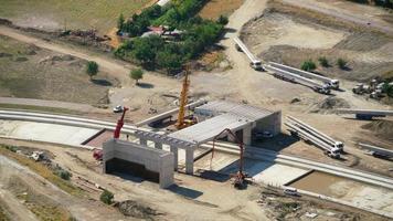 8K Cranes carry concrete spans in bridge construction video